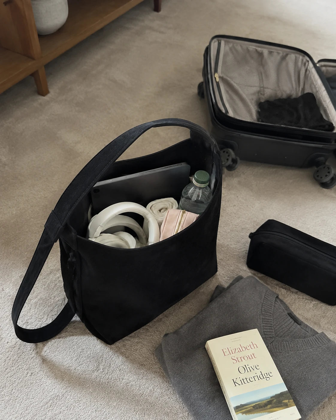 Open Onyx Porter 24 packed for travel beside a suitcase