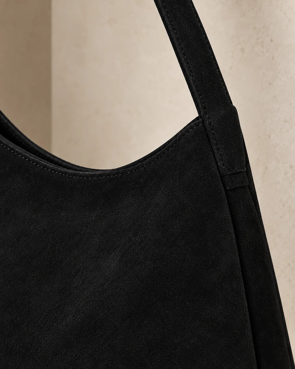 Porter construction — sewn strap join and suede detail
