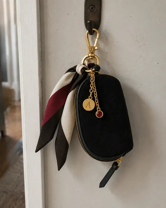 Lifestyle imagery: Styled Black Mini hanging from its clasp on a wall hook